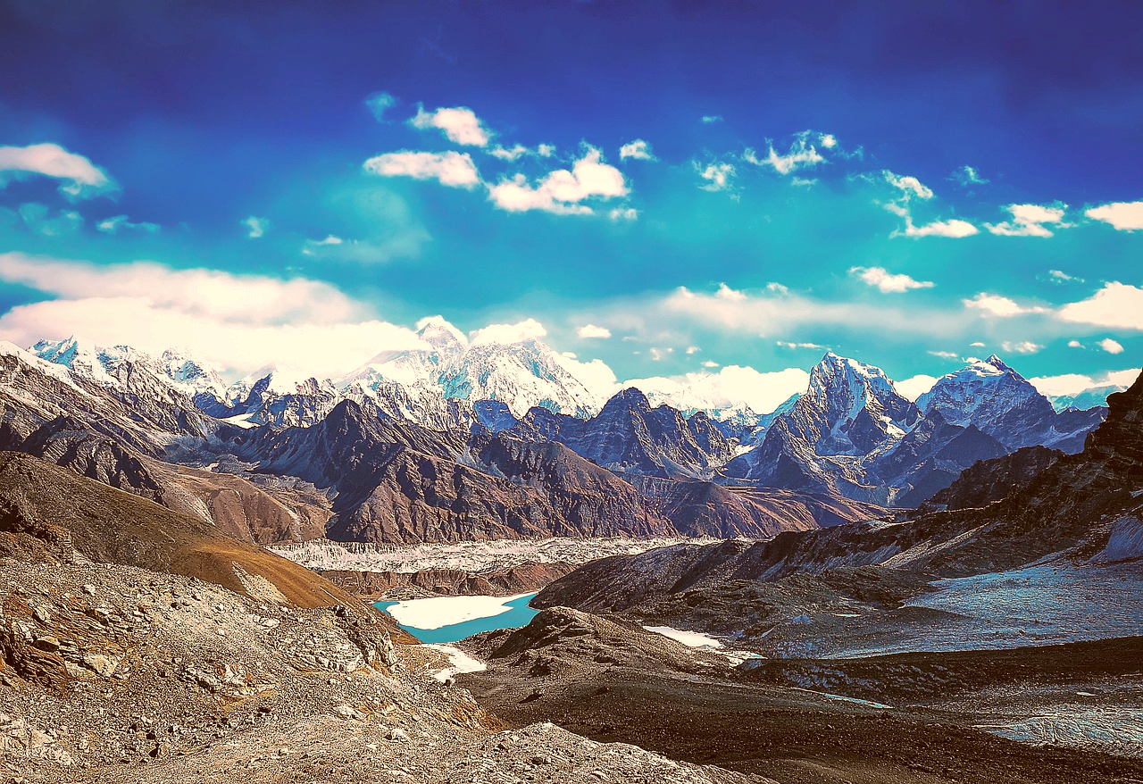 Panoramic view of the Everest Three Passes Trek featuring Gokyo Lake, Ngozumpa Glacier, and snow-capped Himalayan peaks in Nepal.