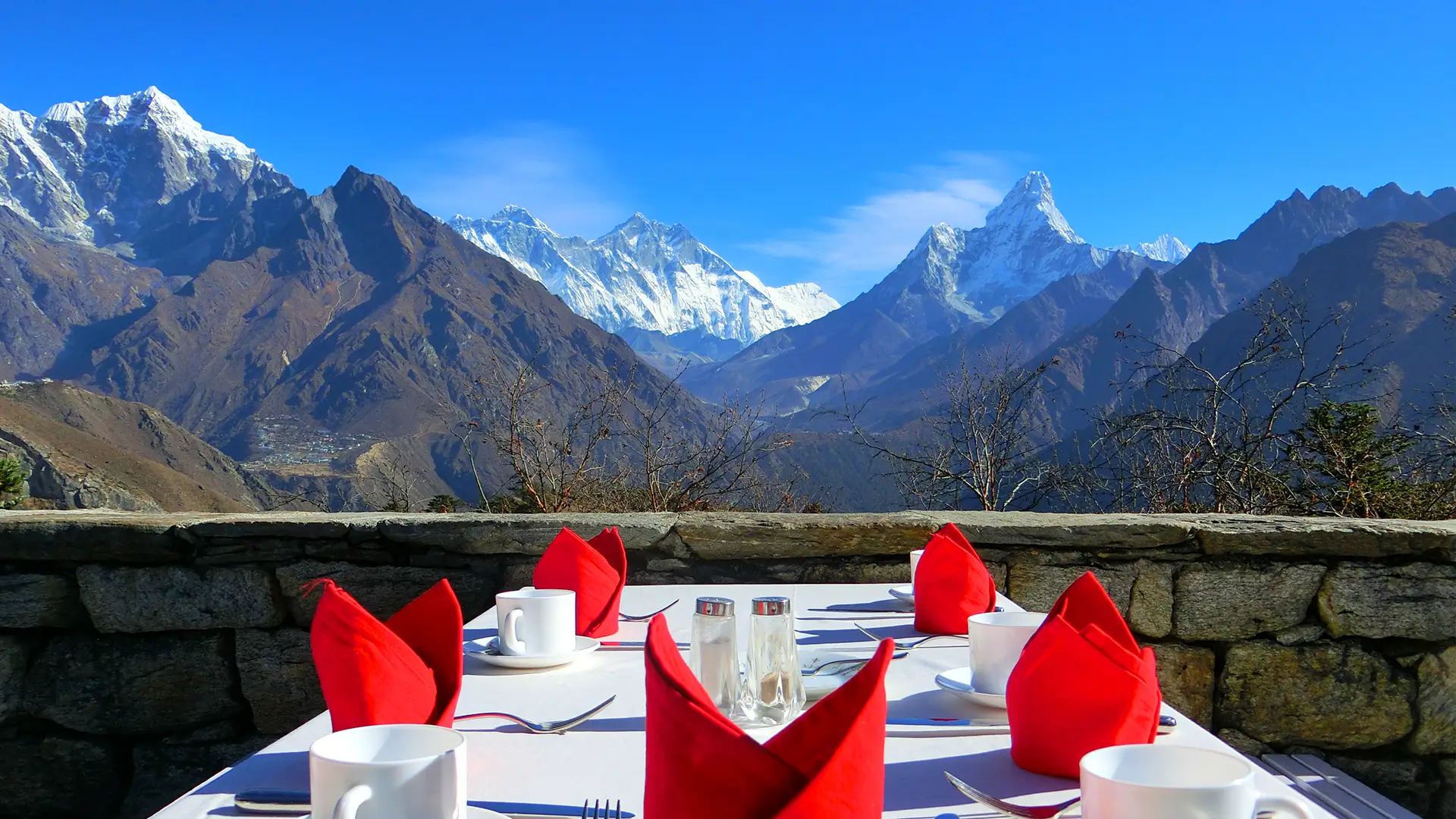 Breakfast table on the Hotel Everest View terrace with Everest, Lhotse, and Ama Dablam on the horizon