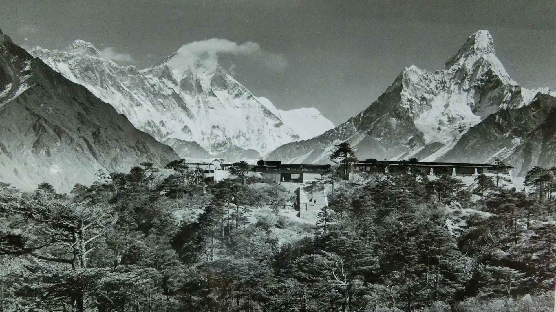 Historic photo of Hotel Everest View on its forested ridge with Everest and Ama Dablam behind